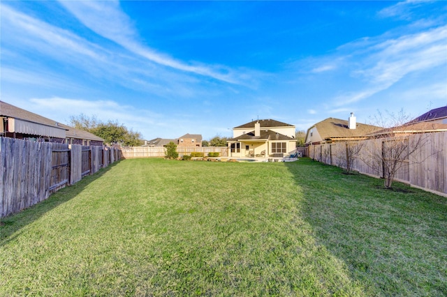 view of yard with a fenced backyard