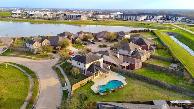 birds eye view of property featuring a residential view and a water view