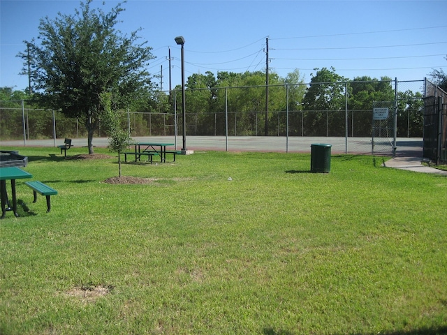 view of home's community featuring fence and a lawn