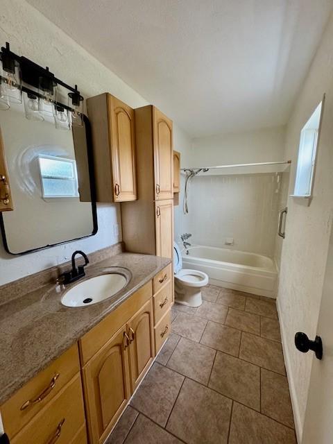 full bathroom featuring tile patterned flooring, toilet, vanity, and tub / shower combination