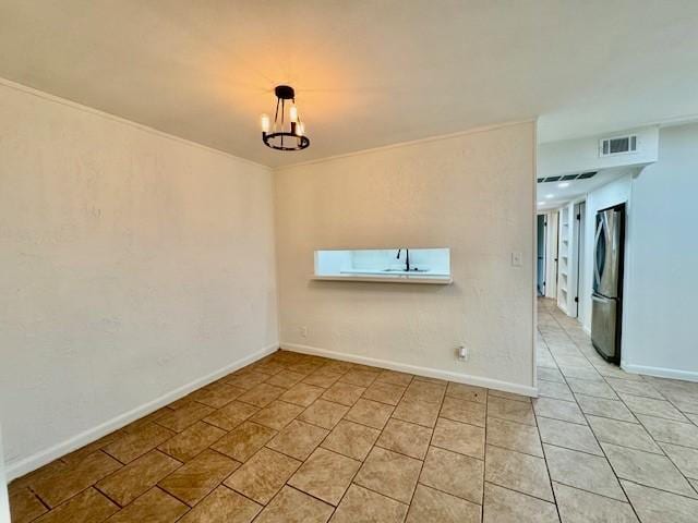 spare room with light tile patterned floors, baseboards, and visible vents