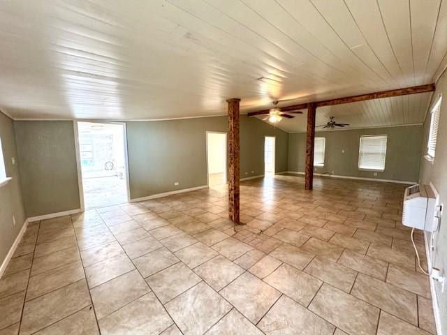 interior space with baseboards, lofted ceiling, wood ceiling, and ornate columns