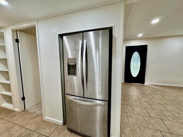 kitchen featuring recessed lighting, light tile patterned flooring, baseboards, and stainless steel fridge