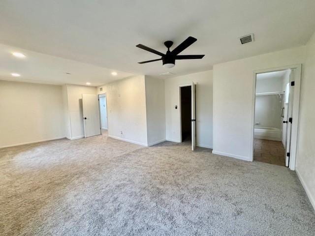 unfurnished room with visible vents, light carpet, a ceiling fan, recessed lighting, and baseboards