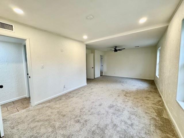 carpeted empty room featuring recessed lighting, a ceiling fan, visible vents, and baseboards