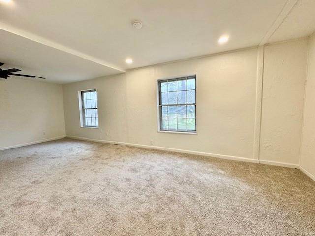 empty room featuring recessed lighting, baseboards, and carpet