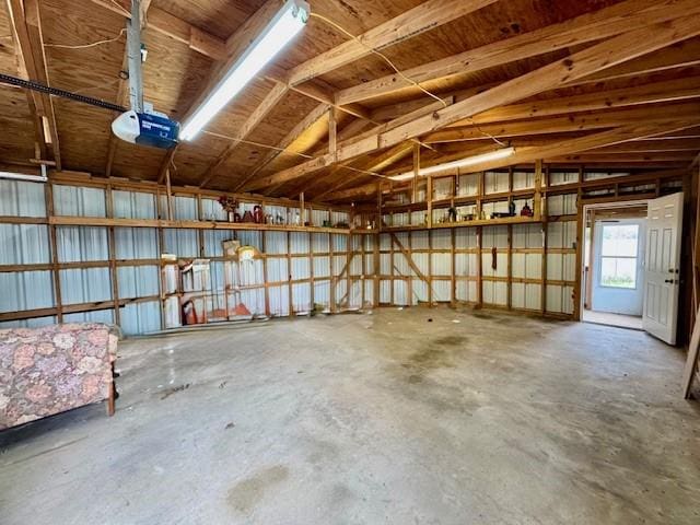 garage with metal wall and a garage door opener