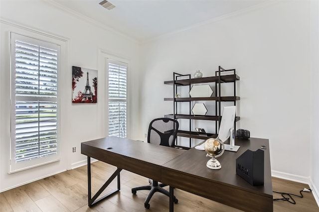 office featuring visible vents, baseboards, wood finished floors, and crown molding