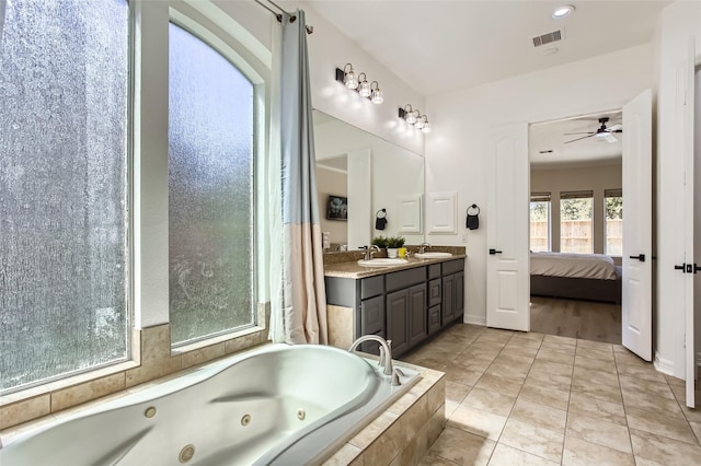 bathroom with ensuite bath, visible vents, a whirlpool tub, and a sink