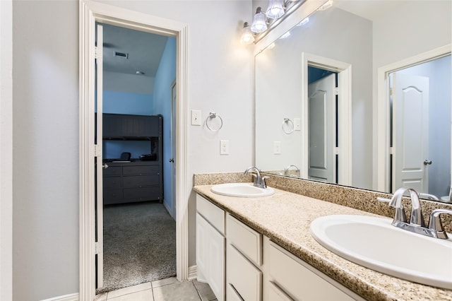 bathroom with tile patterned floors, visible vents, double vanity, and a sink