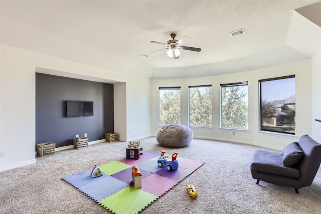 workout area featuring visible vents, baseboards, carpet, and a ceiling fan