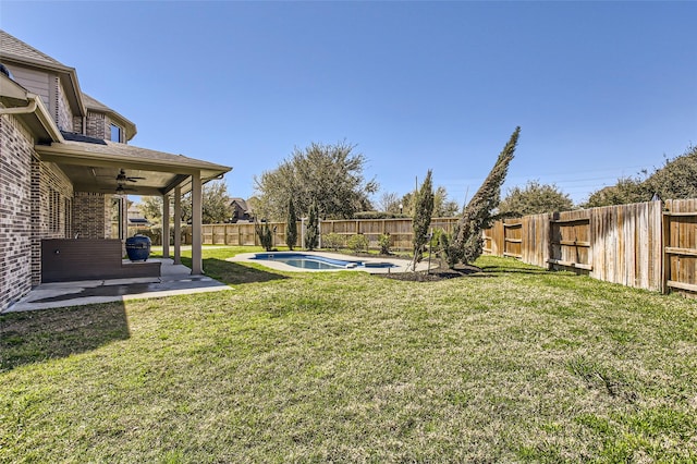 view of yard with a fenced backyard, a patio, a fenced in pool, and ceiling fan