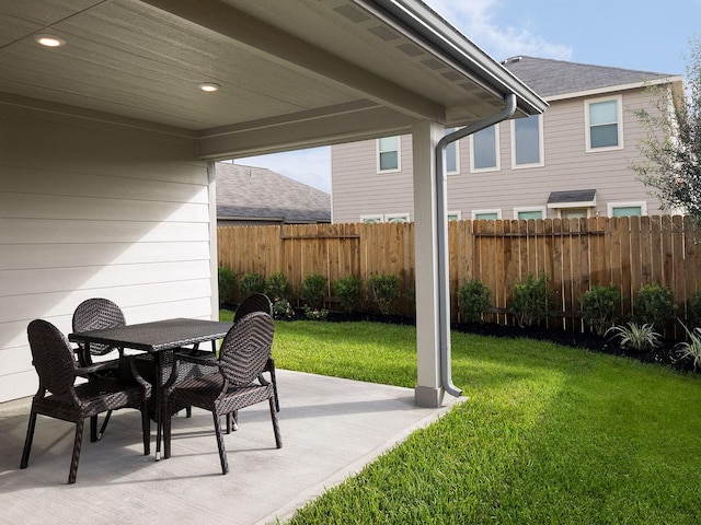 view of patio with outdoor dining space and fence