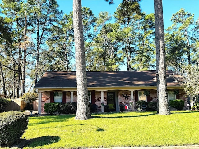 single story home with brick siding, a front lawn, and fence