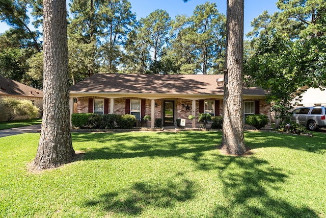 ranch-style home with a front lawn and brick siding