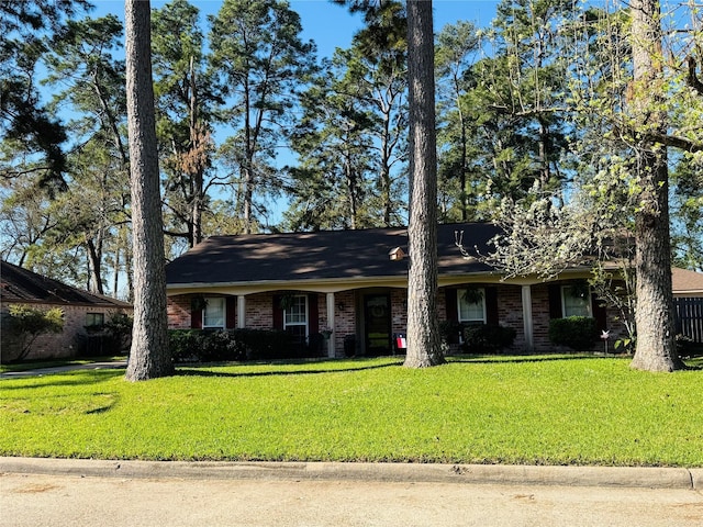 single story home featuring a front lawn and brick siding