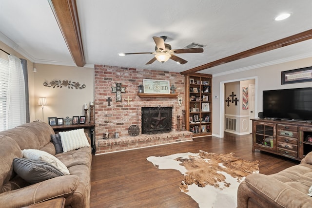 living room with visible vents, beam ceiling, wood finished floors, and a fireplace