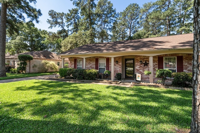 ranch-style house with a front yard, brick siding, and a shingled roof