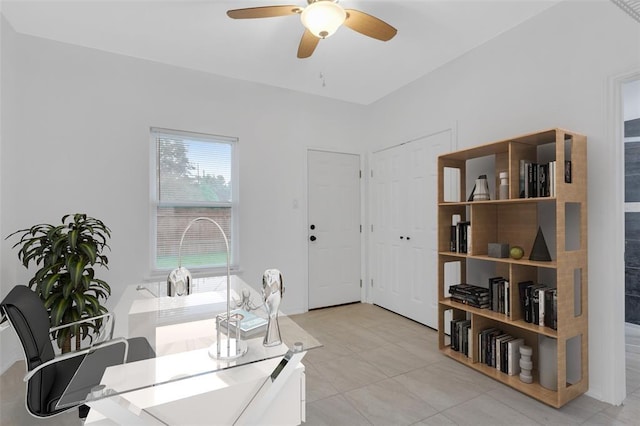 home office featuring light tile patterned flooring and a ceiling fan