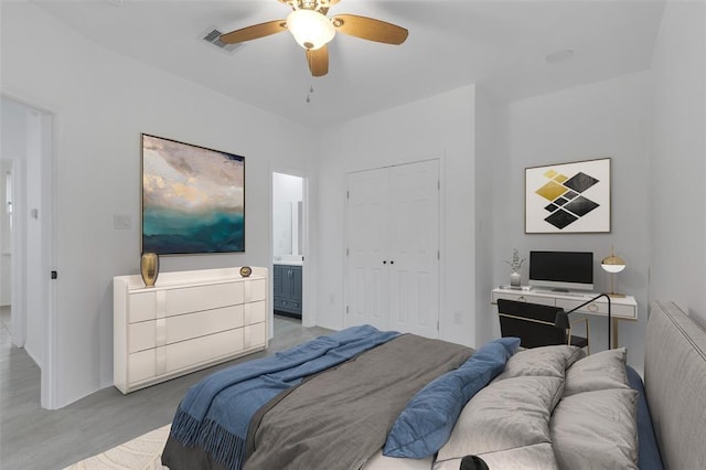 bedroom with ensuite bath, visible vents, a closet, and ceiling fan