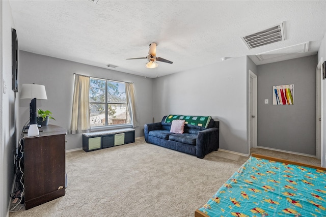 carpeted living area with baseboards, visible vents, and ceiling fan