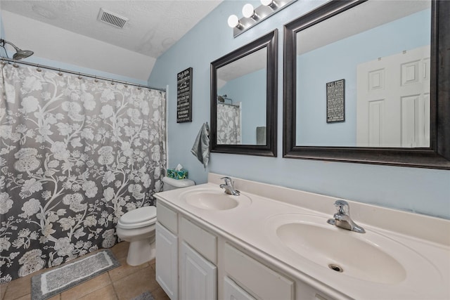 bathroom featuring a sink, visible vents, toilet, and a textured ceiling