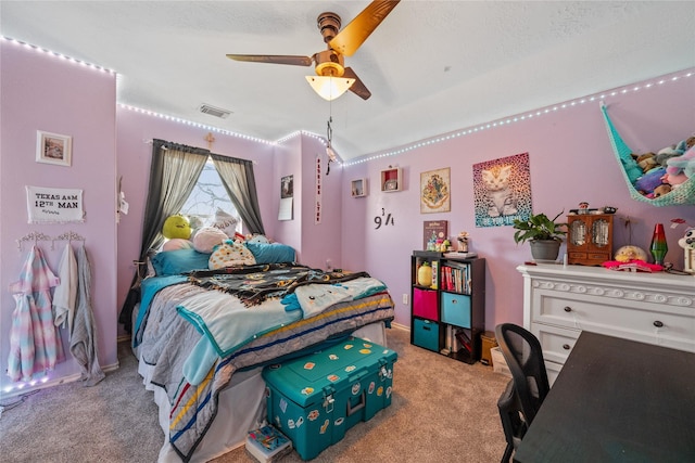 bedroom featuring light carpet, visible vents, and ceiling fan