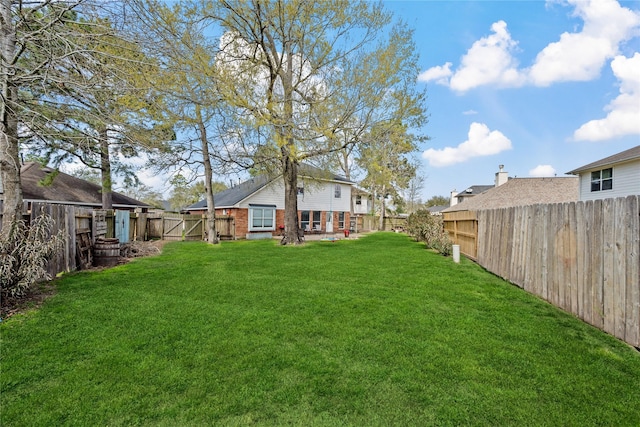 view of yard with a fenced backyard