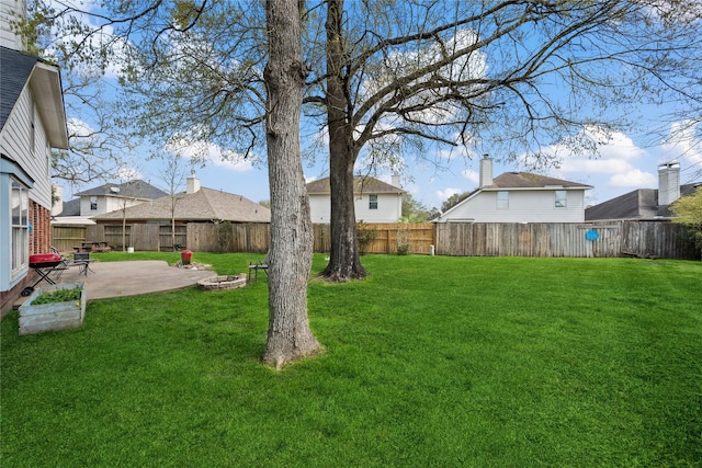 view of yard with a fenced backyard and a patio