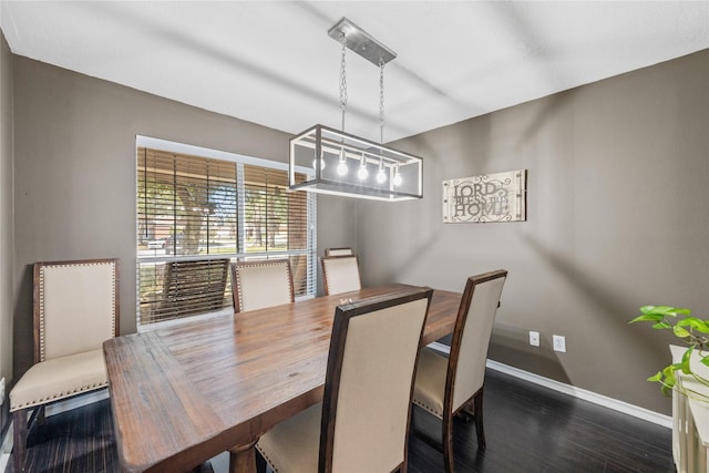 dining area featuring baseboards and dark wood-style floors