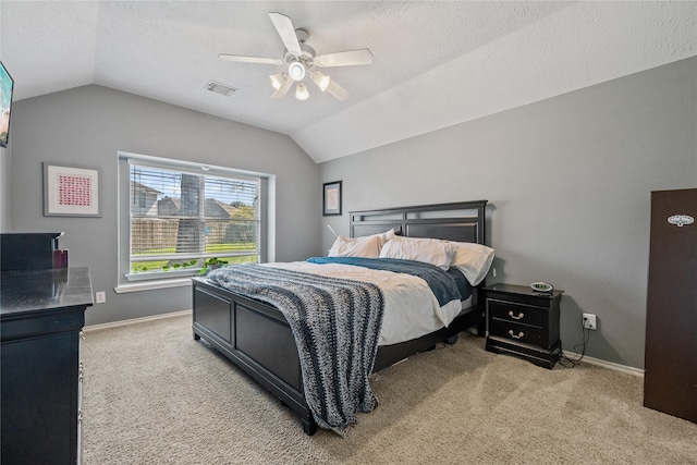 bedroom featuring lofted ceiling, carpet flooring, baseboards, and visible vents