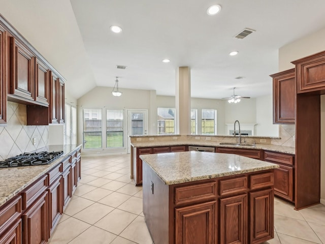 kitchen with gas cooktop, light tile patterned floors, visible vents, and a sink