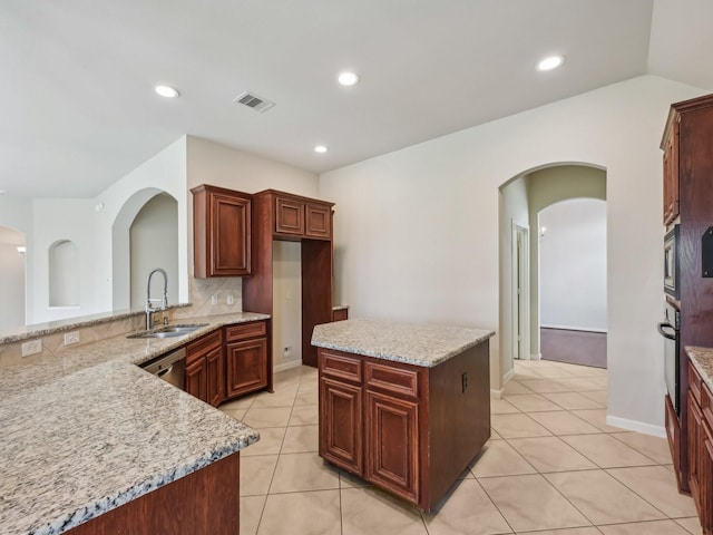 kitchen with visible vents, a sink, backsplash, appliances with stainless steel finishes, and light tile patterned floors