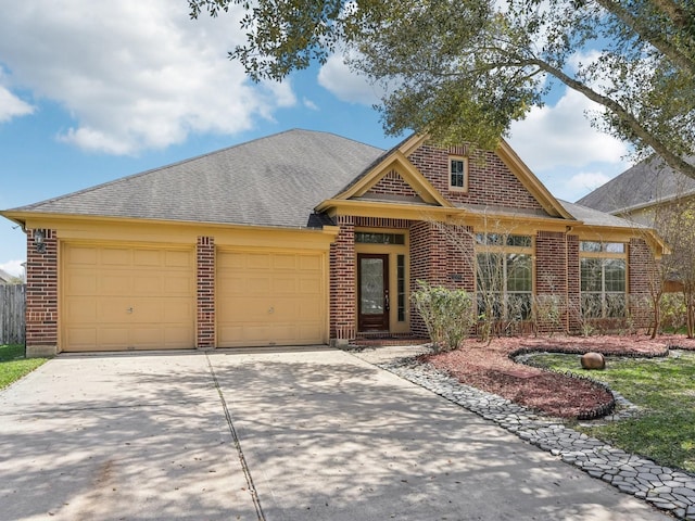 view of front of house with a garage, brick siding, roof with shingles, and concrete driveway