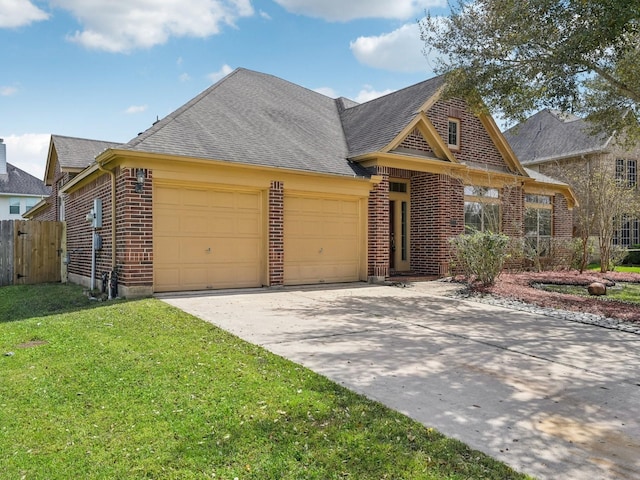 view of front of house featuring fence, driveway, an attached garage, a front lawn, and brick siding