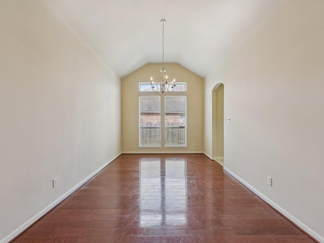 unfurnished dining area featuring a notable chandelier, baseboards, lofted ceiling, and wood finished floors