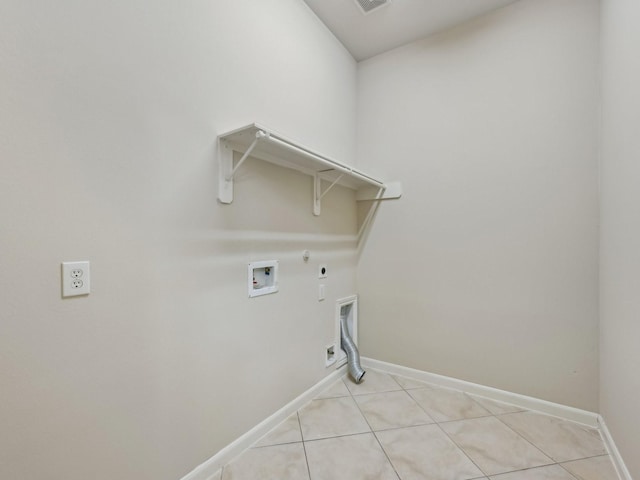 clothes washing area featuring washer hookup, light tile patterned floors, laundry area, hookup for a gas dryer, and hookup for an electric dryer