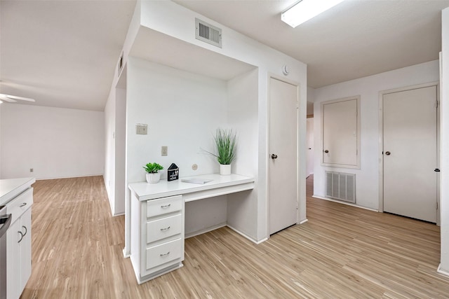 kitchen with visible vents, light wood-style floors, and light countertops