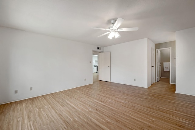 spare room featuring visible vents, light wood-style flooring, and a ceiling fan