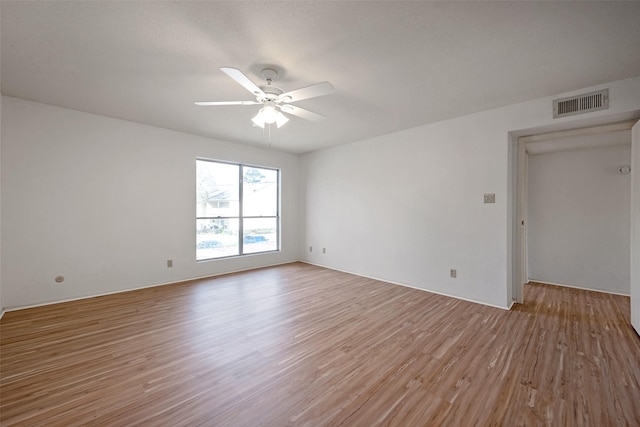 unfurnished room featuring visible vents, ceiling fan, and light wood-style flooring