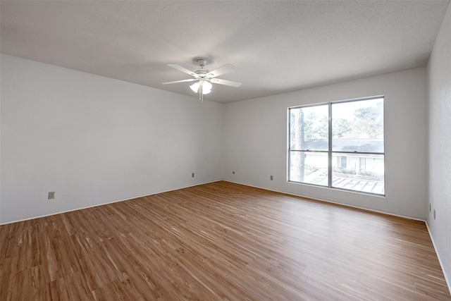 unfurnished room featuring ceiling fan and wood finished floors