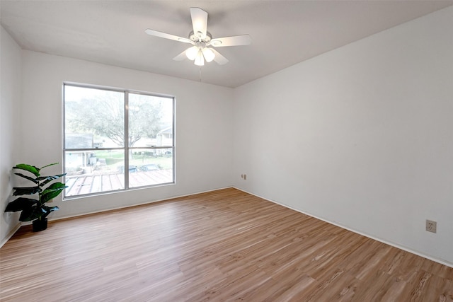 spare room with light wood-type flooring and ceiling fan