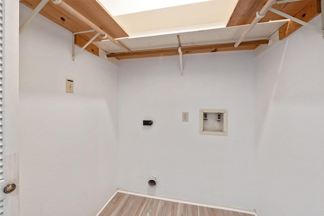 clothes washing area with baseboards, washer hookup, laundry area, wood finished floors, and hookup for an electric dryer