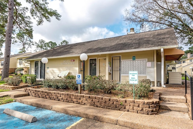 14515 Wunderlich Dr Unit 102, Houston, TX 77069 - view of front of property with roof with shingles and a chimney