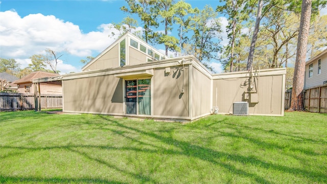 view of outbuilding featuring cooling unit and fence