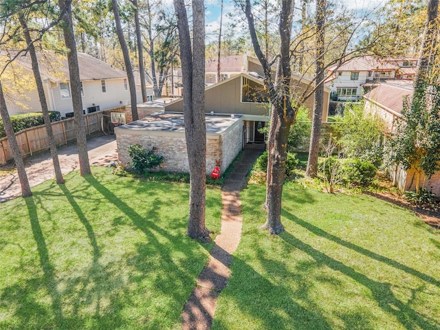 view of yard featuring fence and a residential view