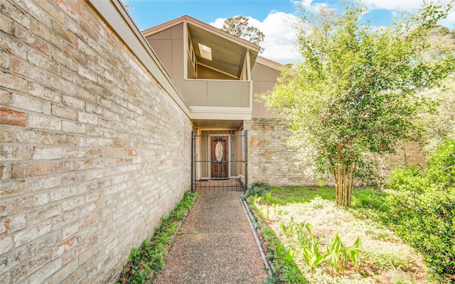 doorway to property featuring brick siding