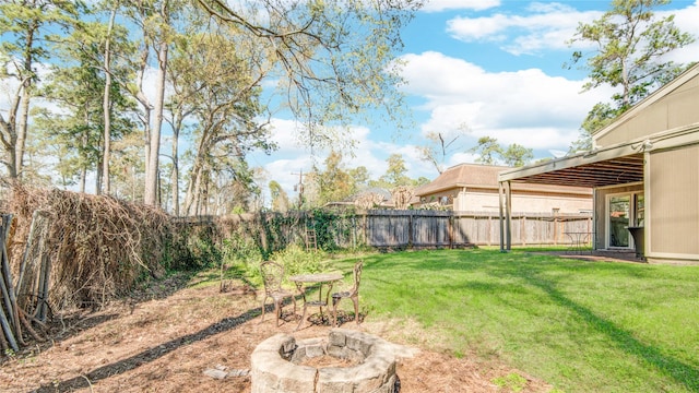 view of yard with a fenced backyard and an outdoor fire pit