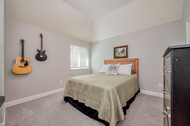 carpeted bedroom with baseboards and lofted ceiling