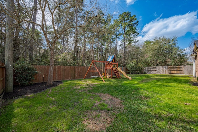 view of yard featuring a playground and a fenced backyard